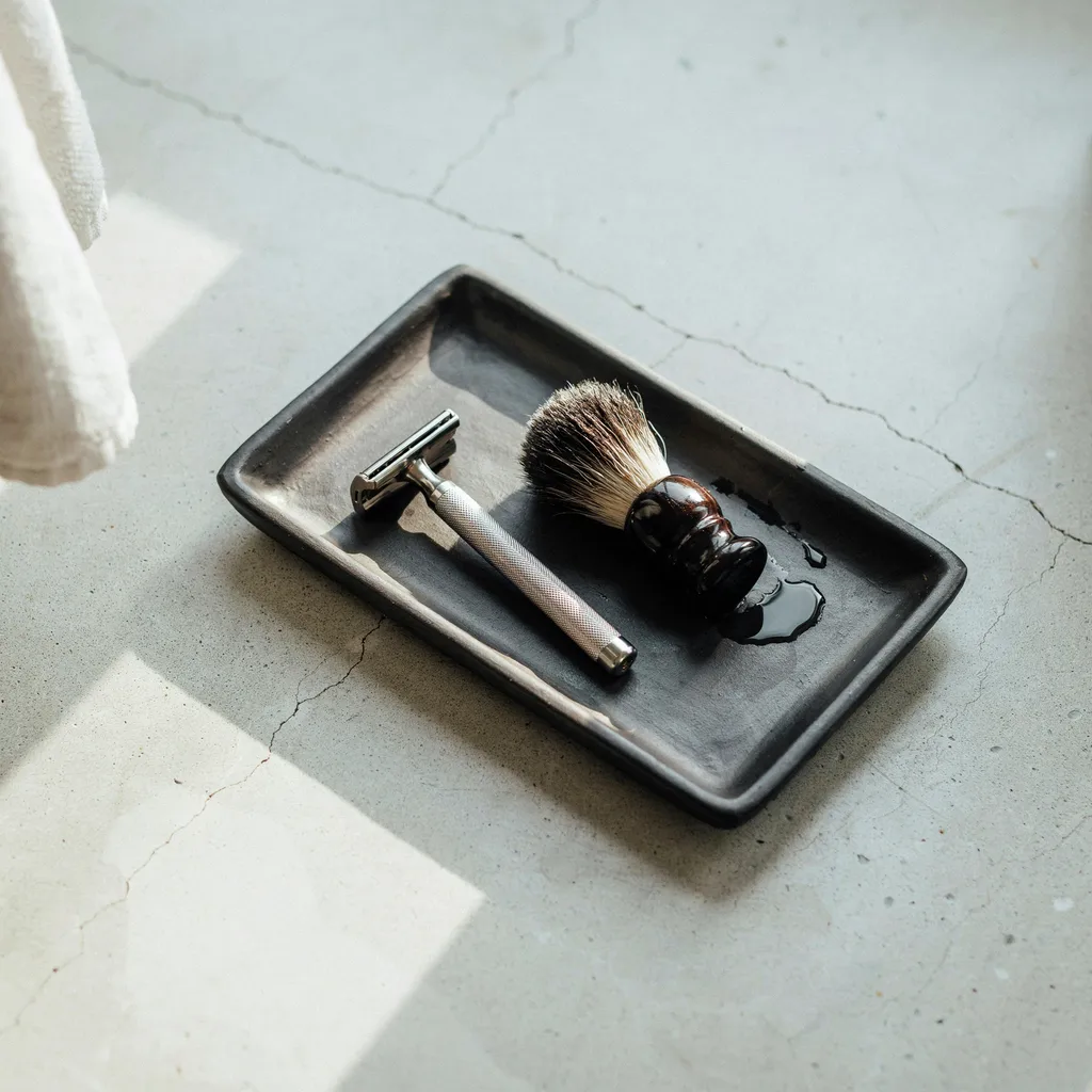 Charcoal black clay tray with grooming tools
