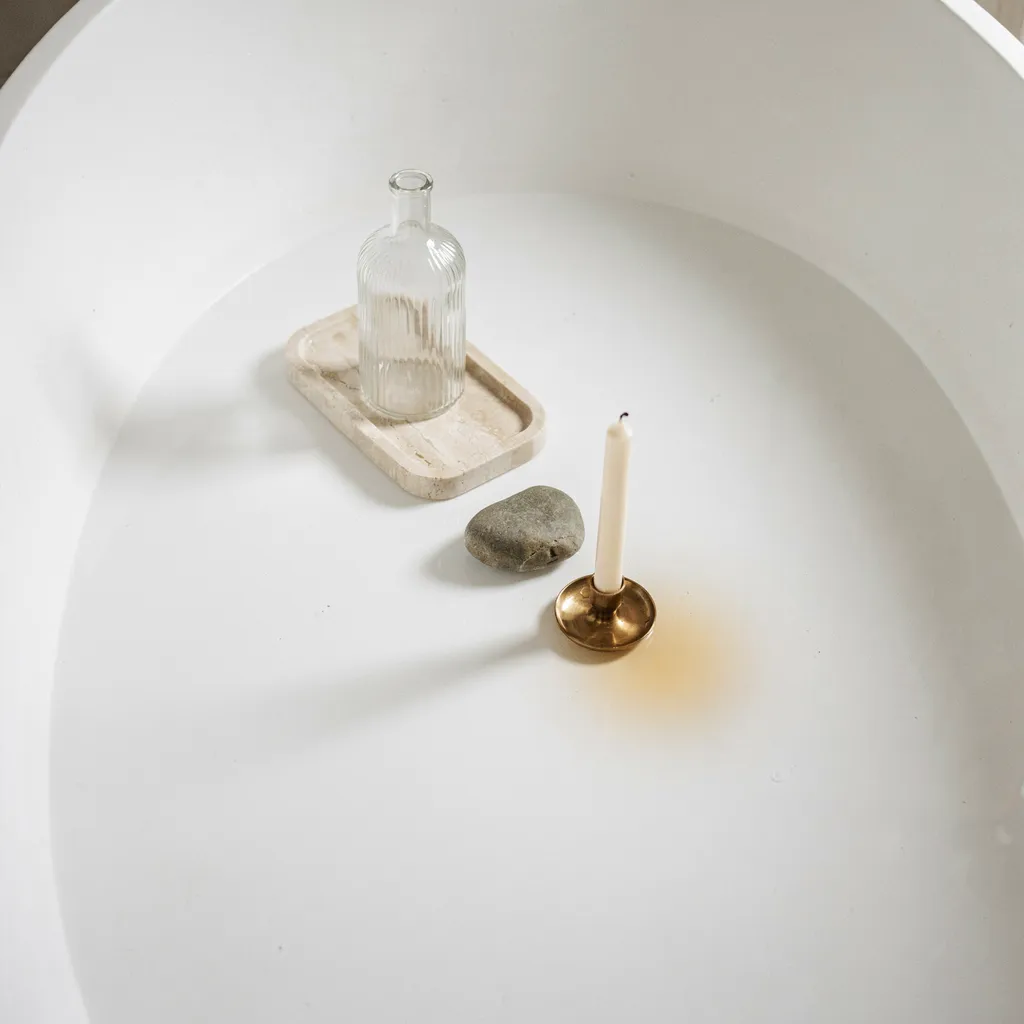 Minimalist three-object styling on a tub deck