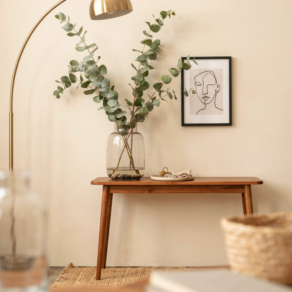Double matte black wall sconces flanking console table