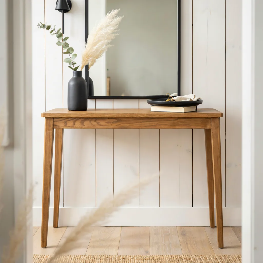 Oak console table with matte black decor accents