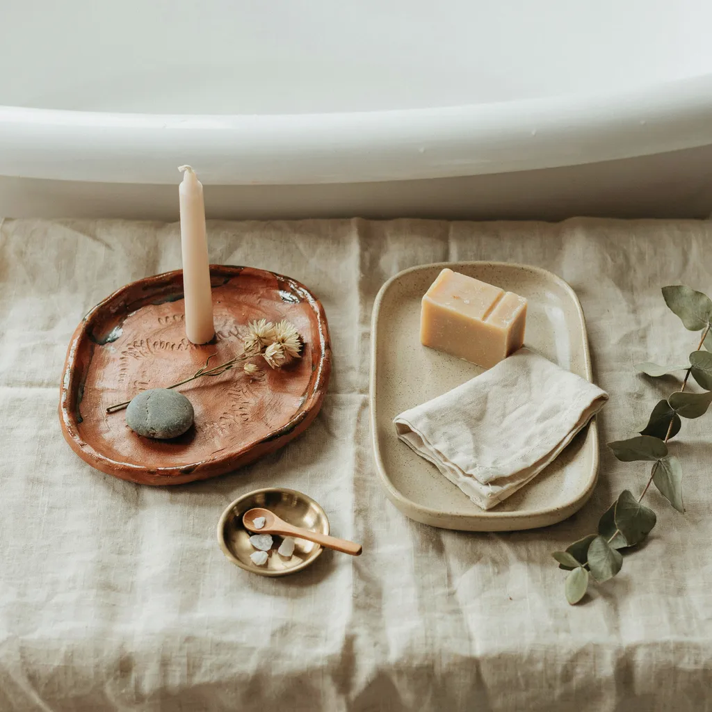 Handcrafted terracotta trays on a tub surround