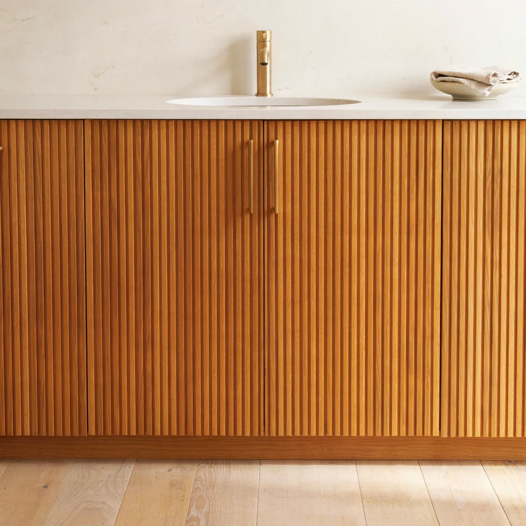 Fluted oak vanity cabinet with brass pulls
