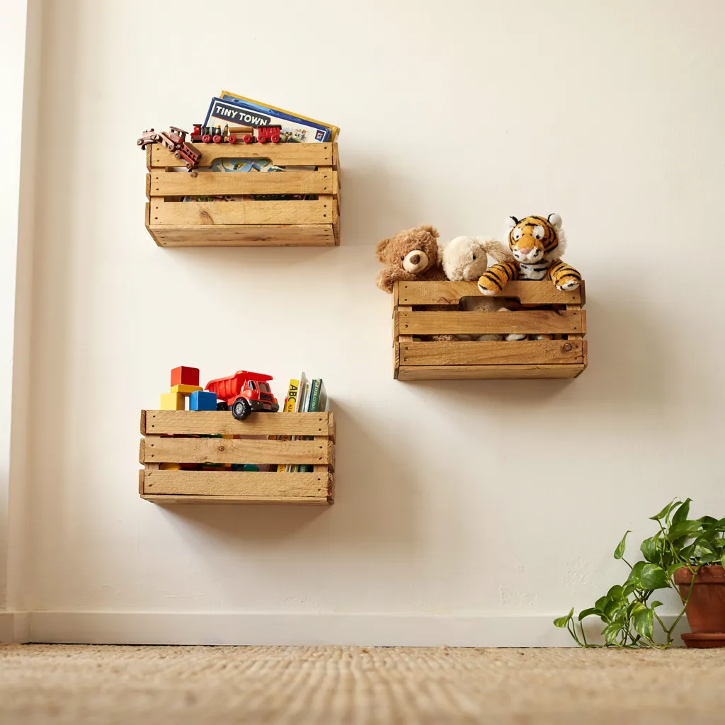 Wall-mounted wooden crates holding toys