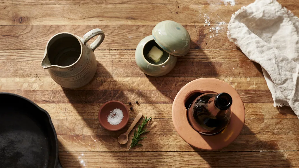Functional clay pottery pieces styled on kitchen counter
