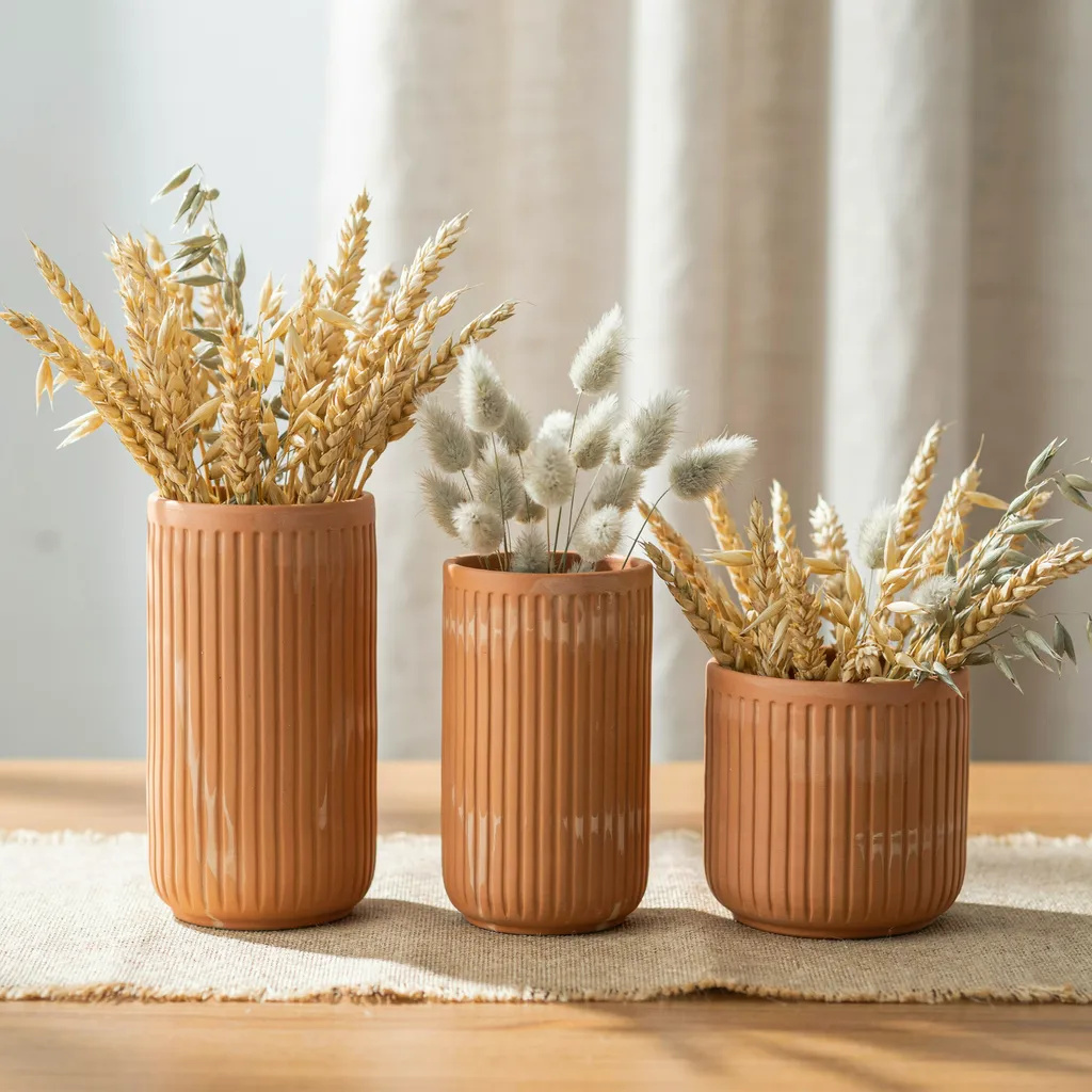 Terracotta pots with dried wheat